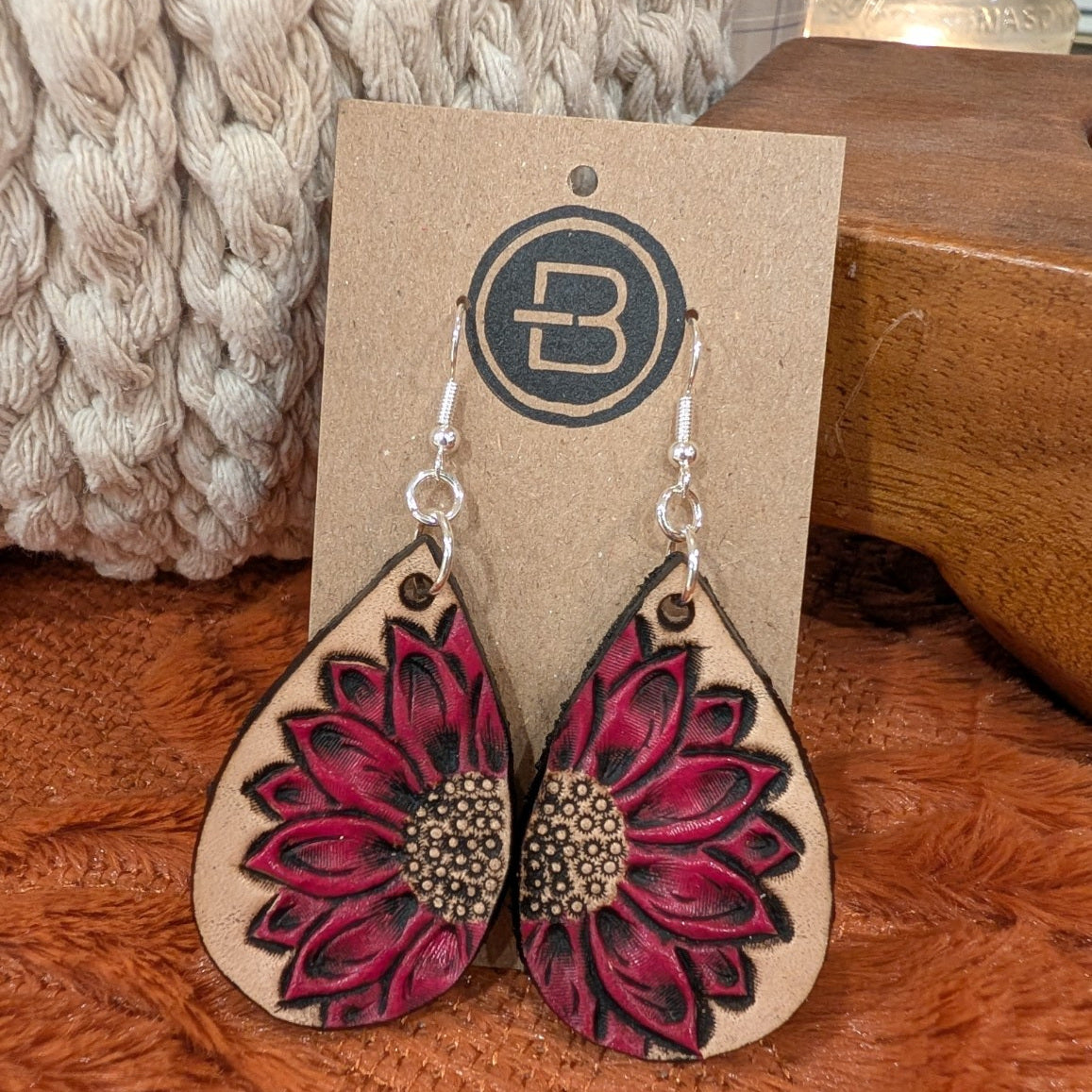 magenta sunflower earrings on branded display card