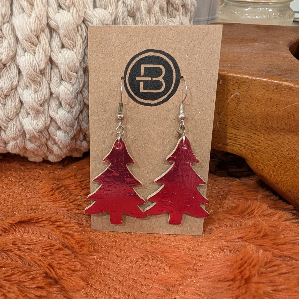 metallic red christmas tree earrings on branded display card