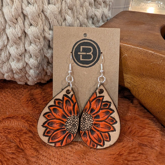 orange sunflower earrings on branded display card