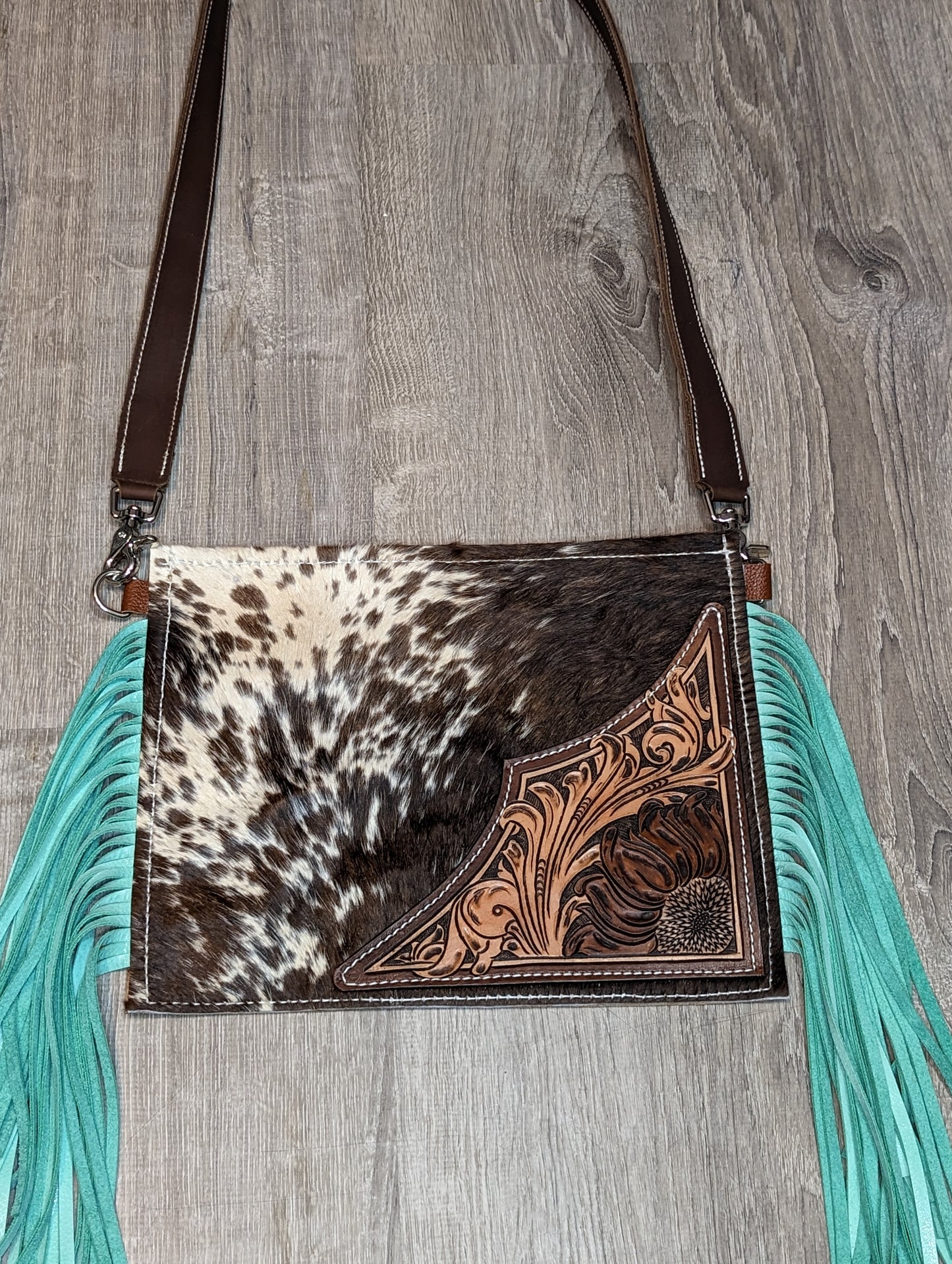 Hair on crossbody purse with tooling and turquoise fringe