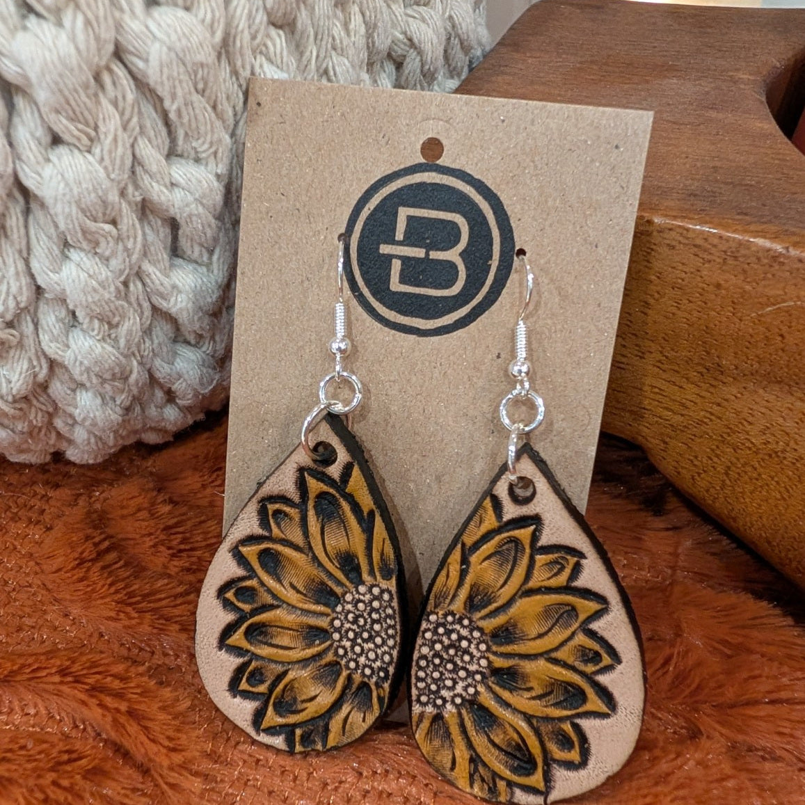 yellow sunflower earrings on branded display card